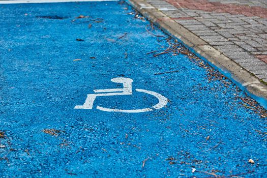 disabled sign painted on asphalt