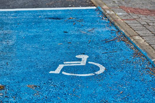 disabled sign painted on asphalt