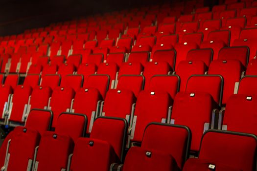 many rows of red theater seats indoors