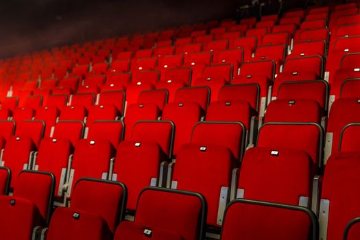 many rows of red theater seats indoors