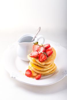 Stack of sweet pancakes with strawberry and honey. Gluten free flour.