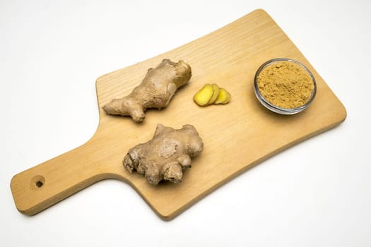 Ginger root, slices and powder on a white background