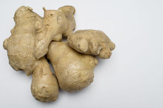 Ginger root disposed on a white background