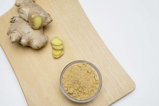 Ginger root, slices and powder on a white background