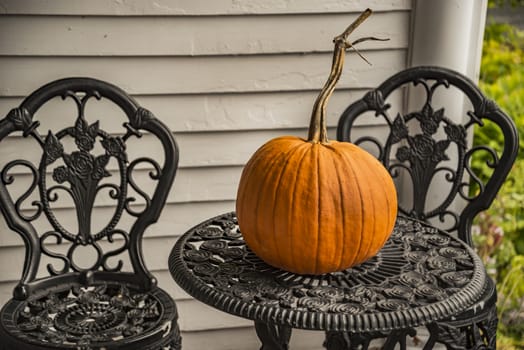 Big orange autumn pumpkin on a garden table