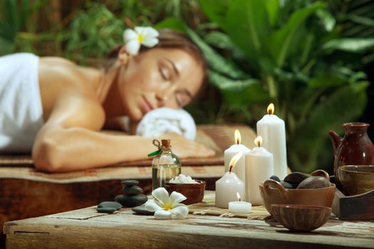 portrait of young beautiful woman  relaxing in spa environment.