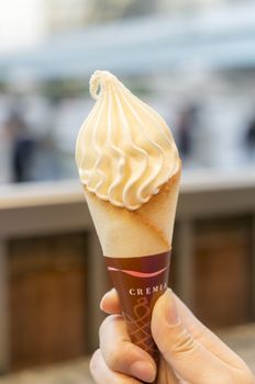  hand holding a creamy ice cream cone