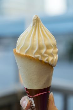 hand holding a creamy ice cream cone