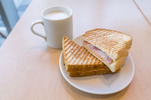 Ham and Cheese Sandwich with a cup of coffee for breakfast