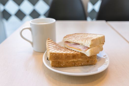 Ham and Cheese Sandwich with a cup of coffee for breakfast