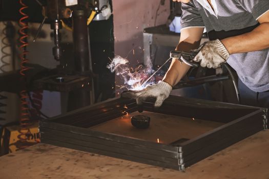 Men welder on a workshop .