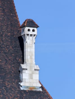 Castle tower roof old white ornate chimney.