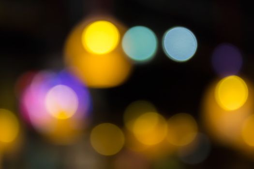 abstract background of blurred warm 
lights with cool blue and purple spots with bokeh effect