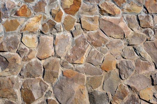 irregular texture of the old yellow stone wall outside