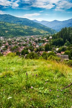 view of little town from the top between mountains in the summer