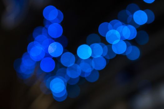 abstract background of blurred cool blue lights with warm yellow spots with bokeh effect