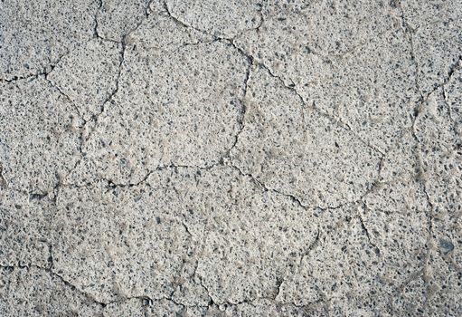 thin fissures and cracks in the gray concrete texture