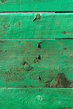 old green wooden boards with bent nails