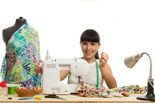 the woman the tailor sews clothes on the sewing machine