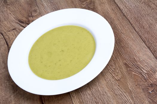 Vegetarian vegetable soup on a wooden table