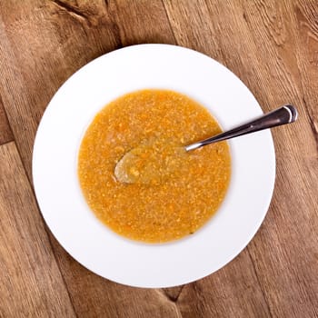 Vegetarian vegetable soup on a wooden table