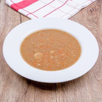 Vegetarian vegetable soup on a wooden table