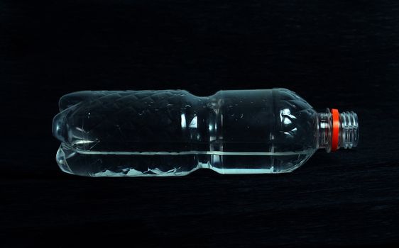 plastic bottle with water on a black background