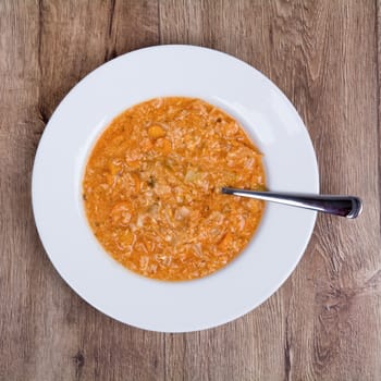 Vegetarian vegetable soup on a wooden table