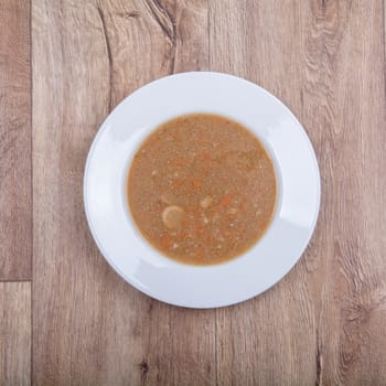 Vegetarian vegetable soup on a wooden table