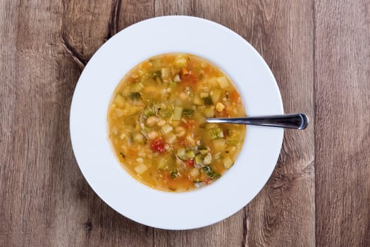 Vegetarian vegetable soup on a wooden table
