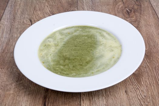 Vegetarian vegetable soup on a wooden table