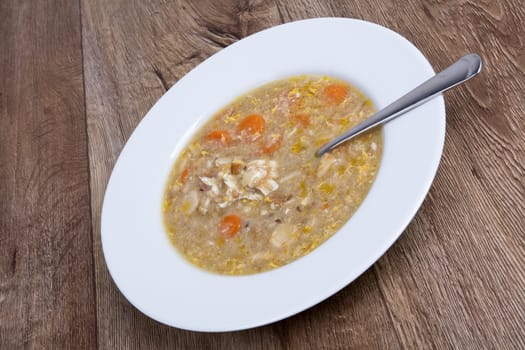 Vegetarian vegetable soup on a wooden table