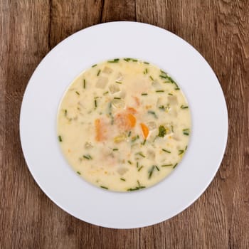 Vegetarian vegetable soup on a wooden table