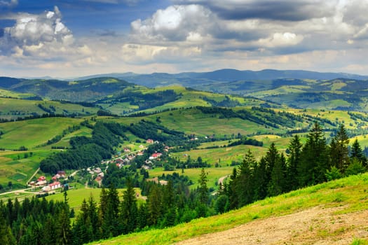 panoramic view from the mountains to the village in a hilly valley