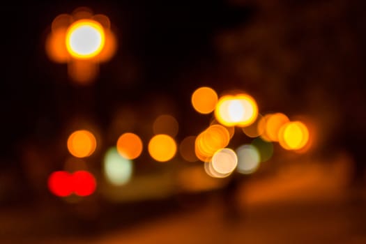 Warm abstract blur of of night lanterns on city street