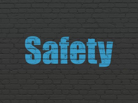 Security concept: Painted blue text Safety on Black Brick wall background