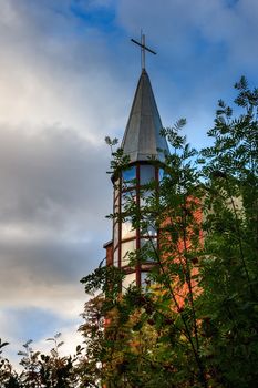 dome of the church is hidden behind branches of viburnum