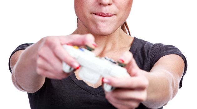 Young woman plays a videogame, isolated on white background