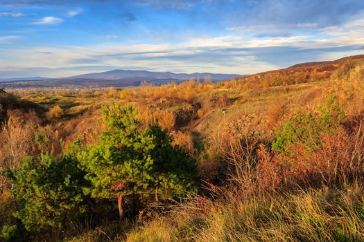 autumn landscape. the view from the high hill to the valley and the mountains far away. vertical