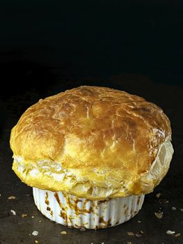 close up of rustic golden english meat pot pie with flaky crust