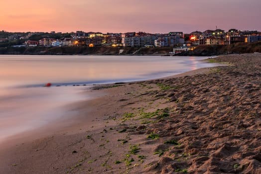 urban sand beach in the early morning calm. resort town wakes up after rough night.