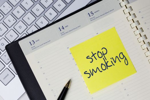 Paper note with the words - Stop smoking - in business desk. Health concept
