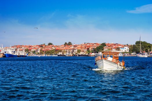 small pleasure boat out to sea from the port of the old town