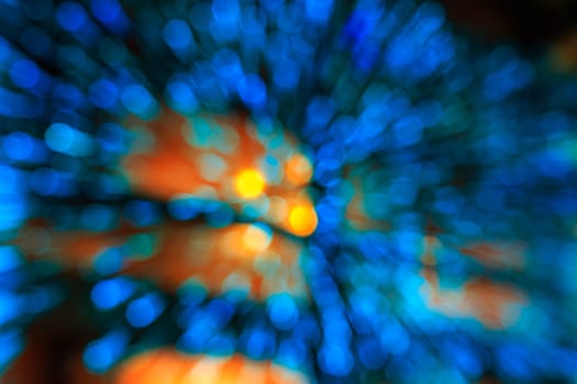 motion zoom of blue light abstract bubbles bokeh with yellow circles in the center