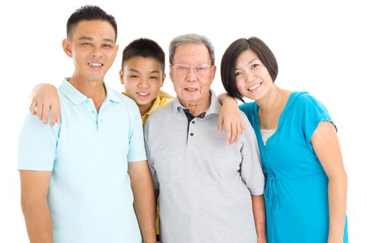 Indoor portrait of beautiful asian 3 generations family over white background