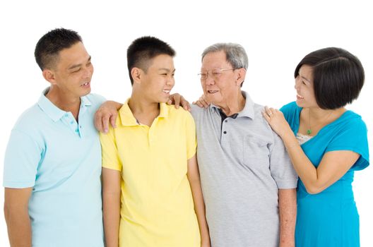 Indoor portrait of beautiful asian 3 generations family over white background
