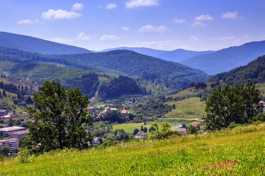 summer landscape. view from the hill over the city in a mountain valley