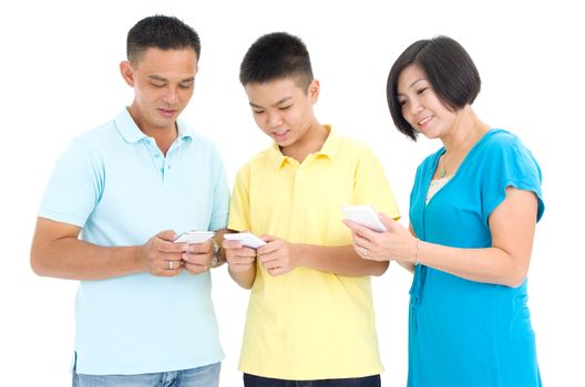 leisure, technology, technology, family and people concept - parent and son with smartphones texting message or playing game at home