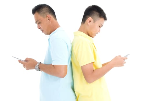 Mother and her son busy with smartphones at home