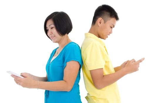 Mother and her son busy with smartphones at home